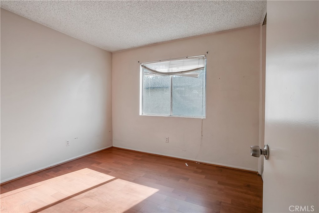 2321 Gonzaga Lane Riverside, CA 92507 - Photo 11 of 24 a view of an empty room with wooden floor and a window
