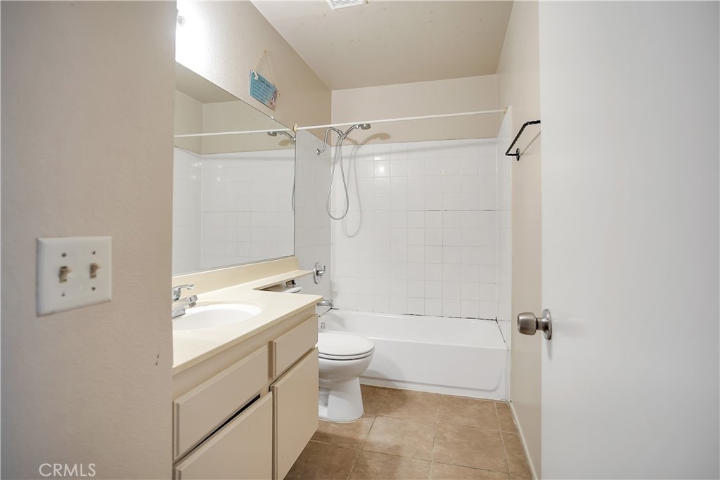 2321 Gonzaga Lane Riverside, CA 92507 - Photo 13 of 24 a bathroom with a granite countertop sink a toilet and shower