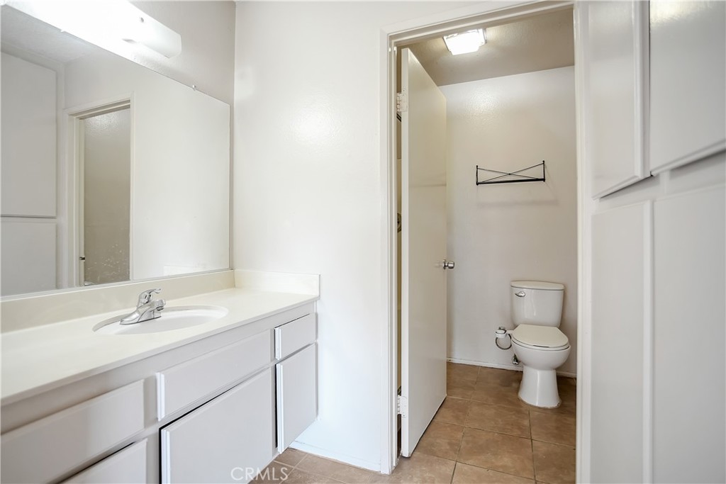 2321 Gonzaga Lane Riverside, CA 92507 - Photo 19 of 24 a bathroom with a sink a toilet a shower and a mirror