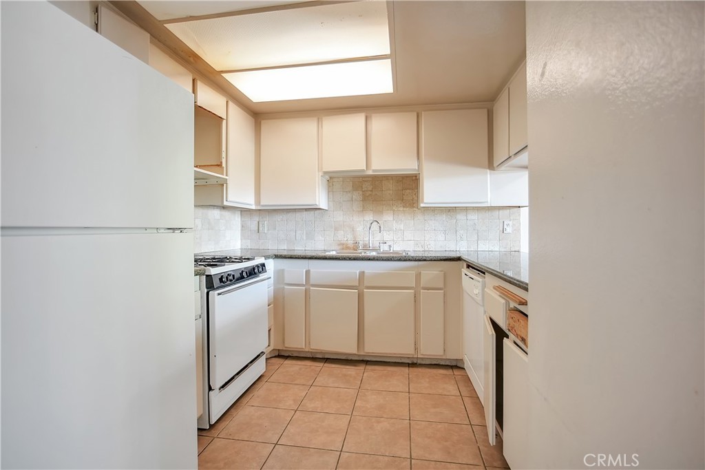 2321 Gonzaga Lane Riverside, CA 92507 - Photo 5 of 24 a kitchen with stainless steel appliances granite countertop a sink and a refrigerator