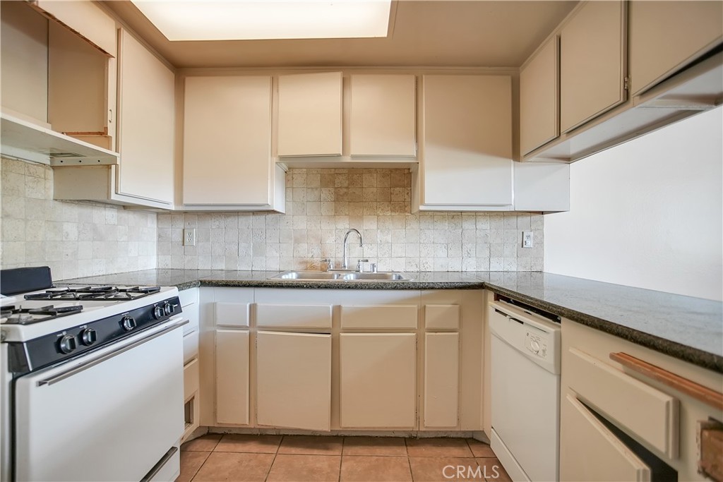 2321 Gonzaga Lane Riverside, CA 92507 - Photo 9 of 24 a kitchen with stainless steel appliances granite countertop a sink stove and cabinets