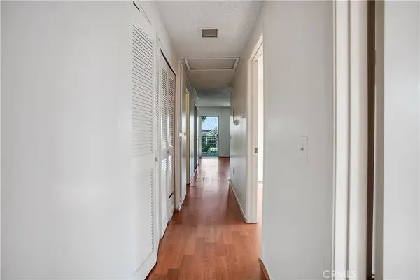 a view of a hallway with wooden floor
