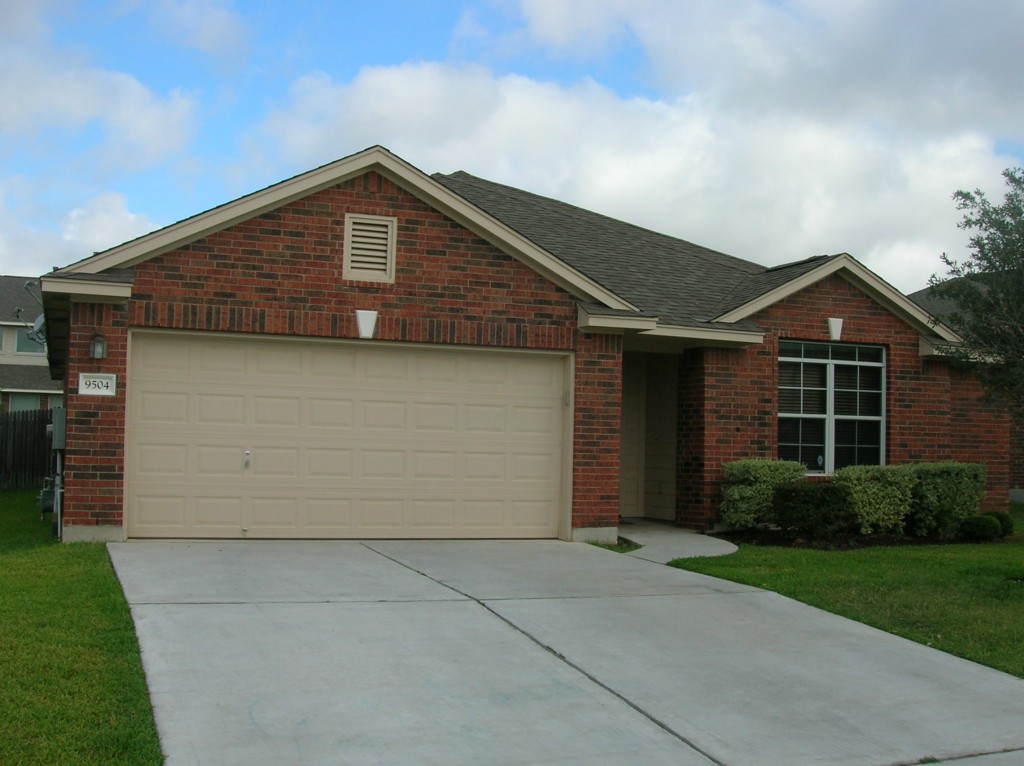 9504 Castle Pines Drive Austin, TX 78717 - Photo 1 of 12 a front view of a house with a yard and garage
