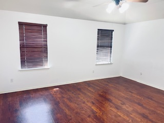 9504 Castle Pines Drive Austin, TX 78717 - Photo 12 of 12 an empty room with wooden floor and windows