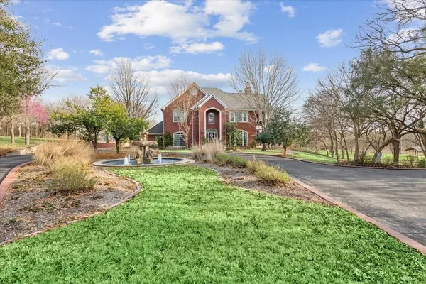 a view of a yard with a house in the background