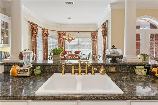 a large white kitchen with a large window