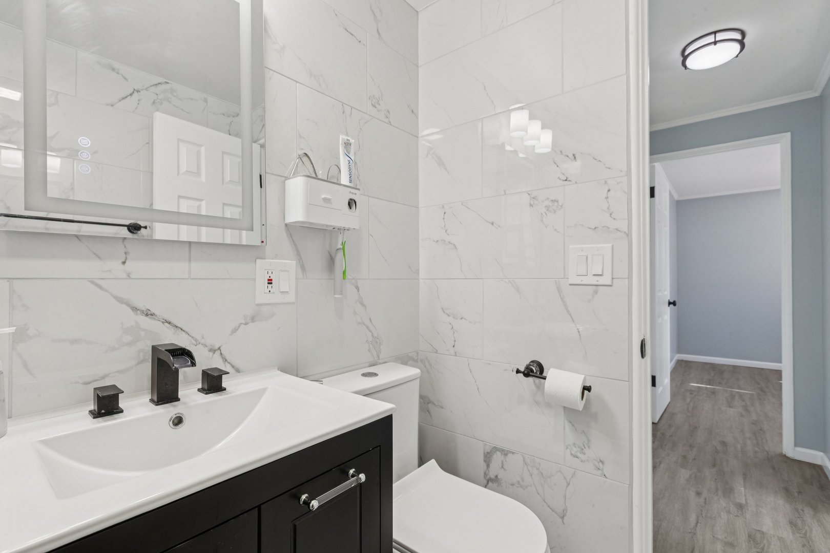 8846 Austin Avenue Morton Grove, IL 60053 - Photo 16 of 35 a bathroom with a sink a toilet and shower