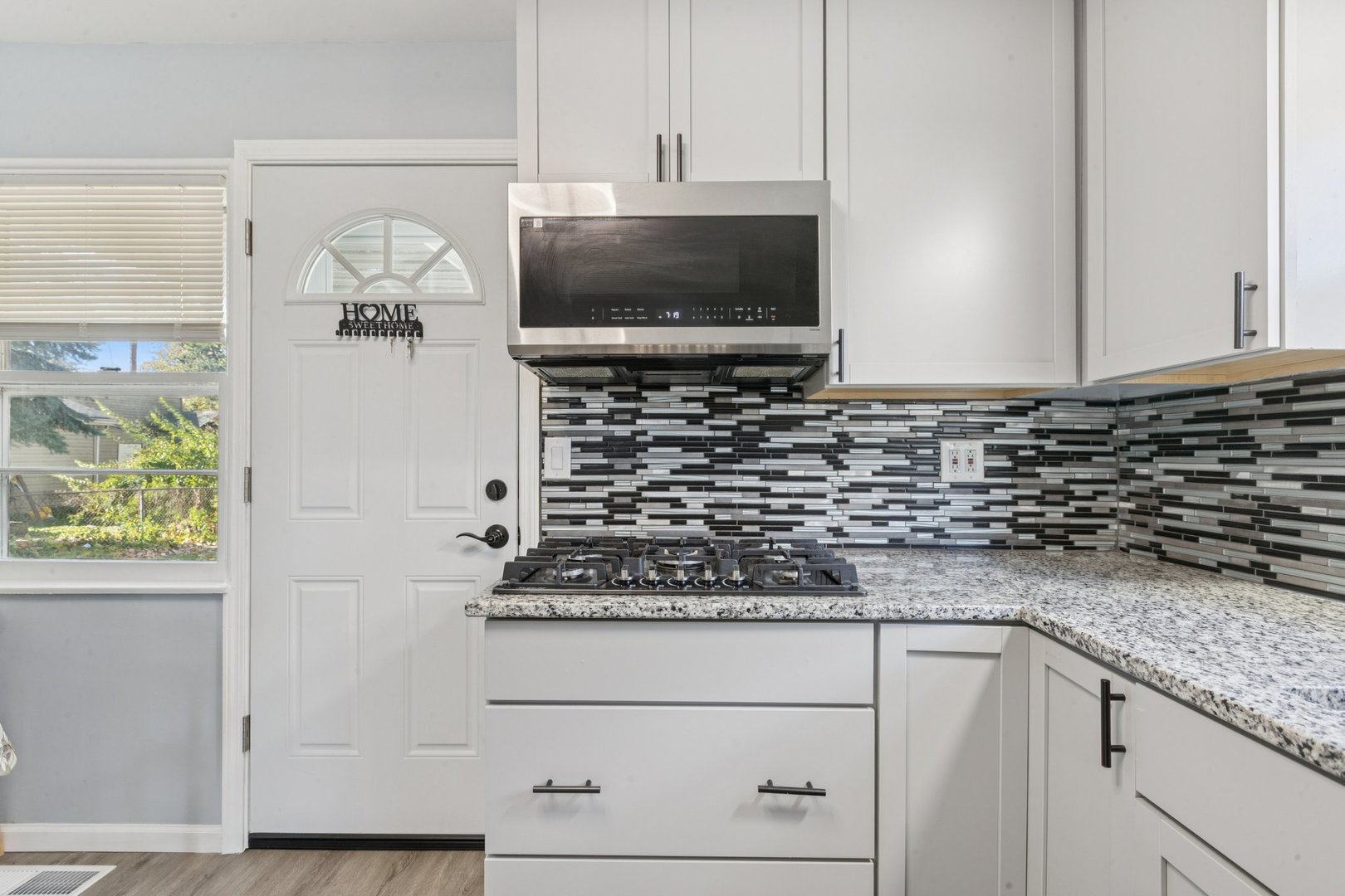 8846 Austin Avenue Morton Grove, IL 60053 - Photo 8 of 35 a kitchen with a stove and a microwave