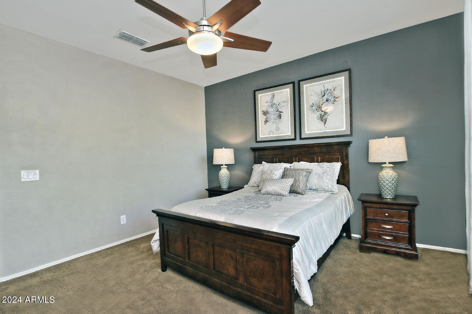 4394 North Hummingbird Drive Florence, AZ 85132 - Photo 16 of 32 a bedroom with a bed and a lamp on dresser