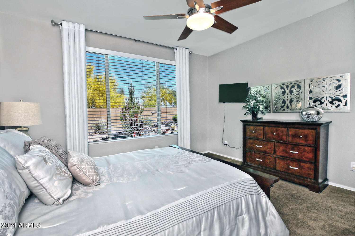 4394 North Hummingbird Drive Florence, AZ 85132 - Photo 17 of 32 a bedroom with a bed a dresser and a large mirror