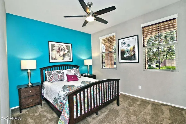 a bedroom with a bed and a chandelier