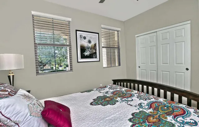 a bedroom with a bed and a window