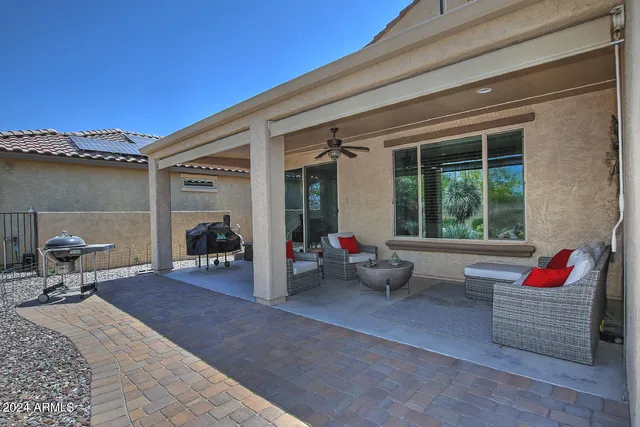 a living room filled with furniture gym equipment and a large window
