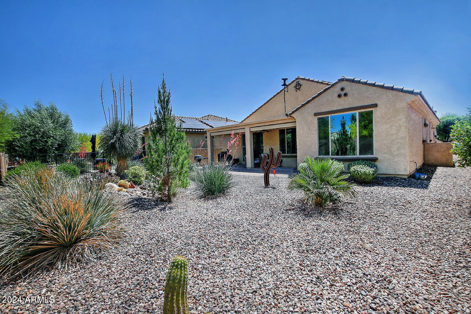 4394 North Hummingbird Drive Florence, AZ 85132 - Photo 32 of 32 a view of a house with a small yard and plants