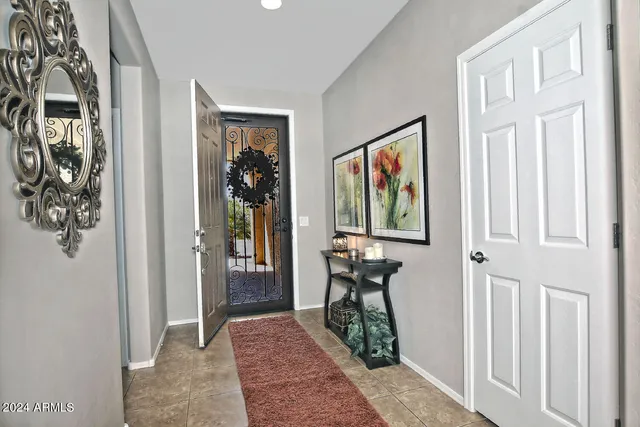 a view of a hallway with wooden floor and windows