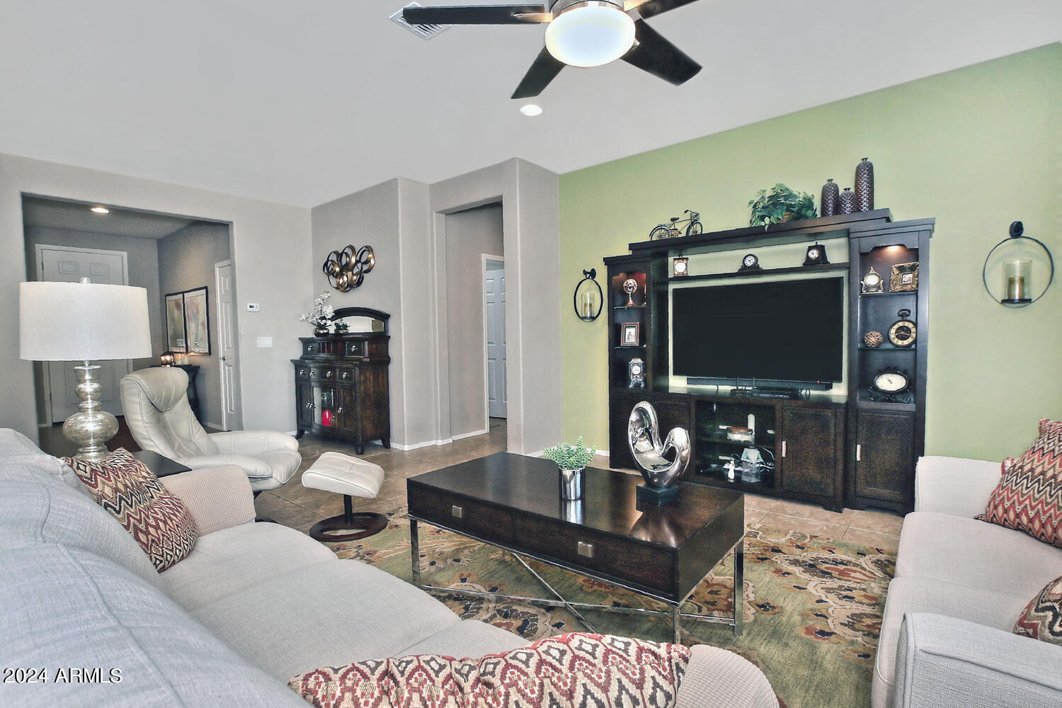 4394 North Hummingbird Drive Florence, AZ 85132 - Photo 6 of 32 a living room with furniture a flat screen tv and a dining table