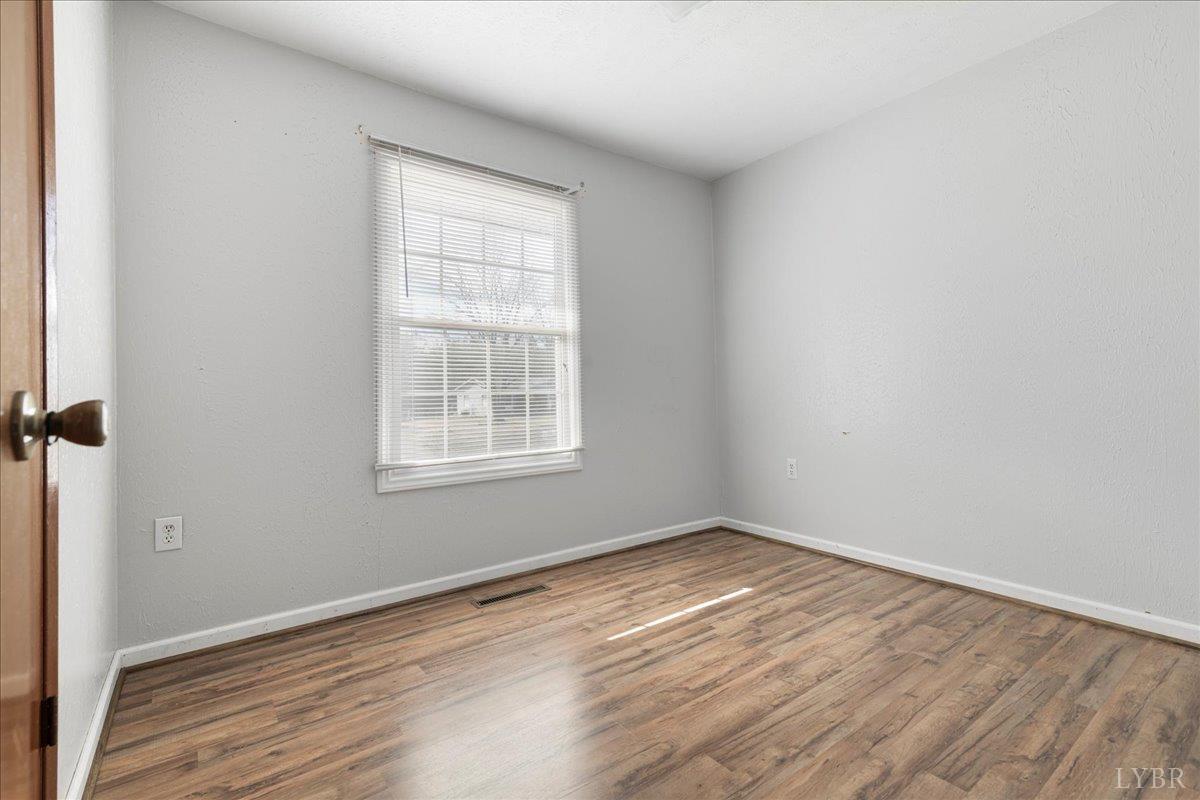 813 Doss Road Concord, VA 24538 - Photo 18 of 31 an empty room with wooden floor and windows