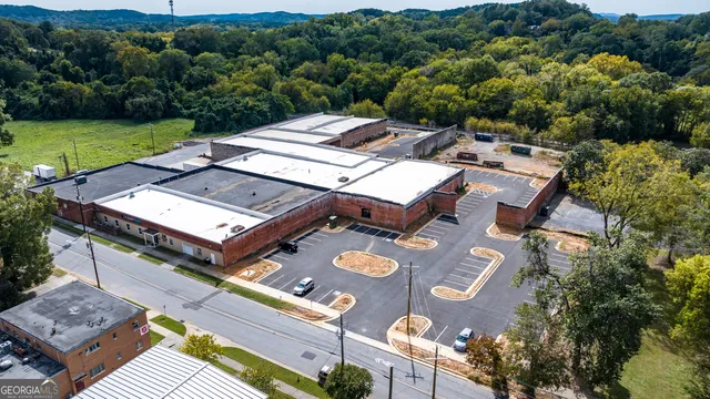 an aerial view of a house with a big yard