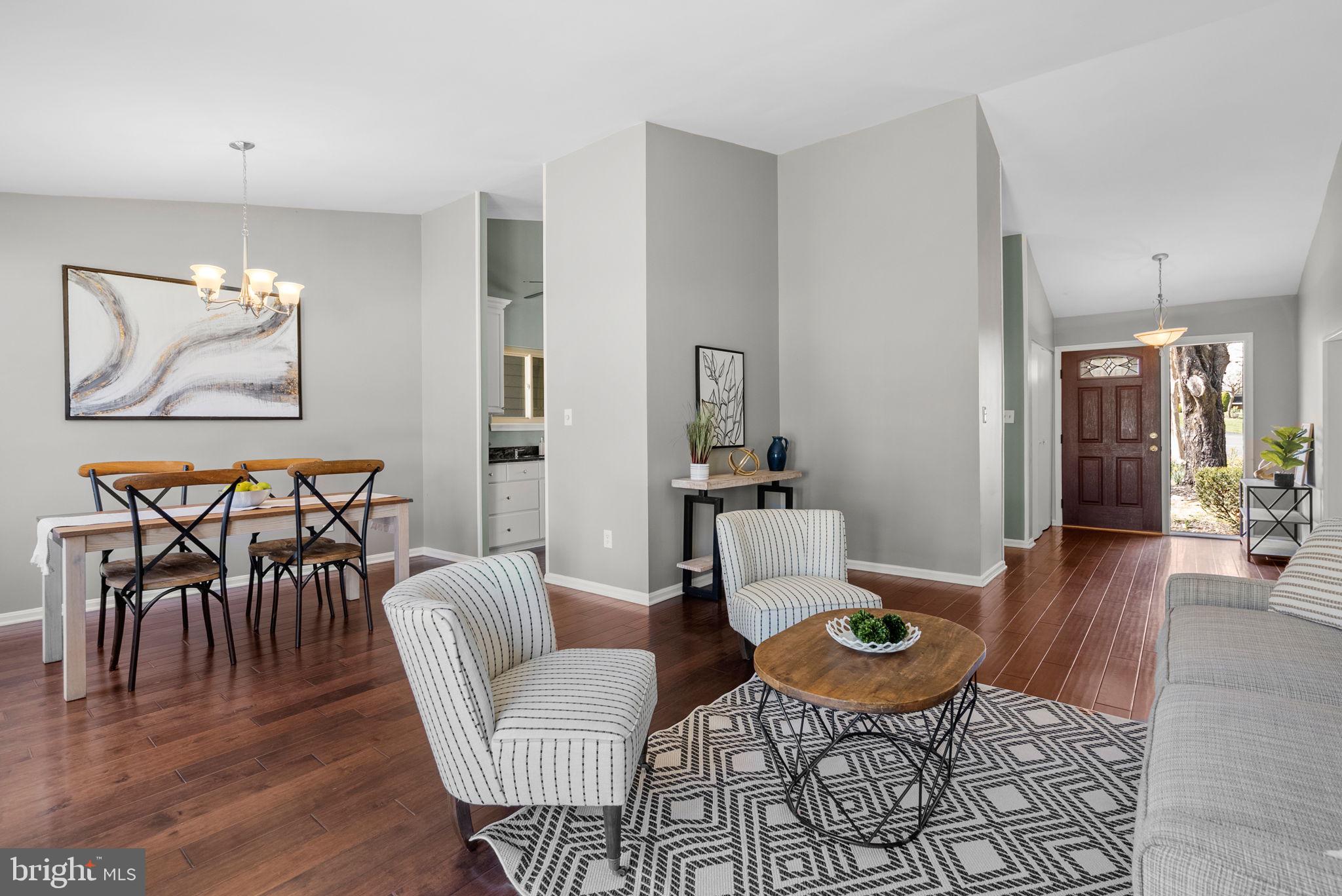 9828 Moyer Road Damascus, MD 20872 - Photo 11 of 46 a living room with furniture a rug and a painting on the wall