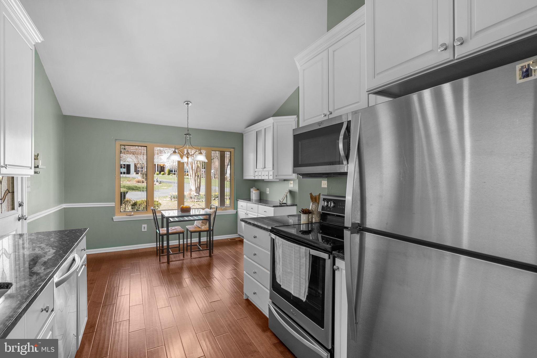 9828 Moyer Road Damascus, MD 20872 - Photo 15 of 46 a kitchen with granite countertop a refrigerator stove and sink
