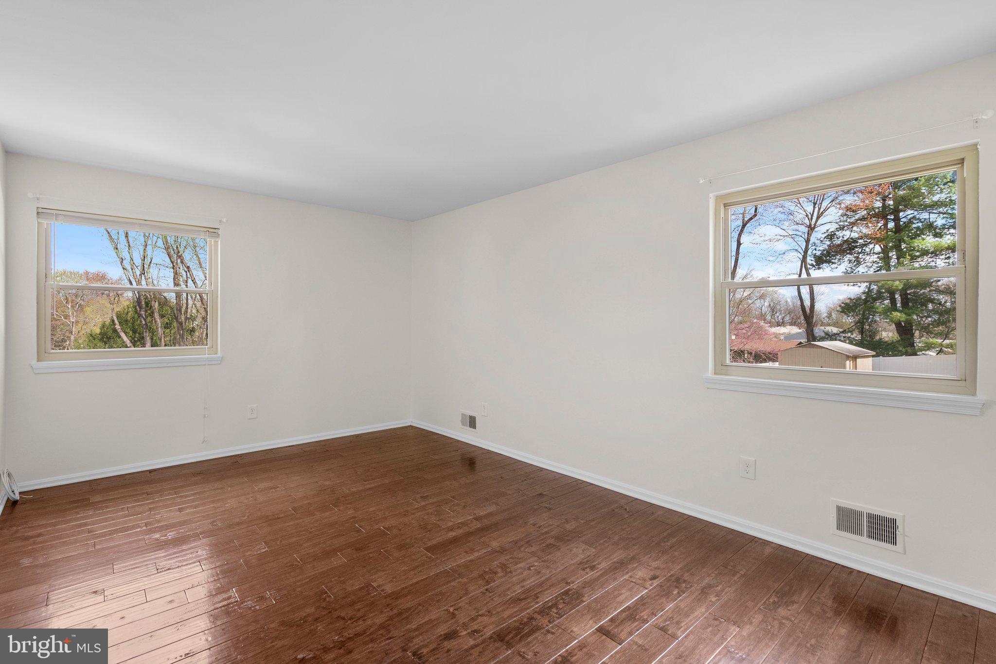9828 Moyer Road Damascus, MD 20872 - Photo 21 of 46 a view of an empty room with wooden floor and a window
