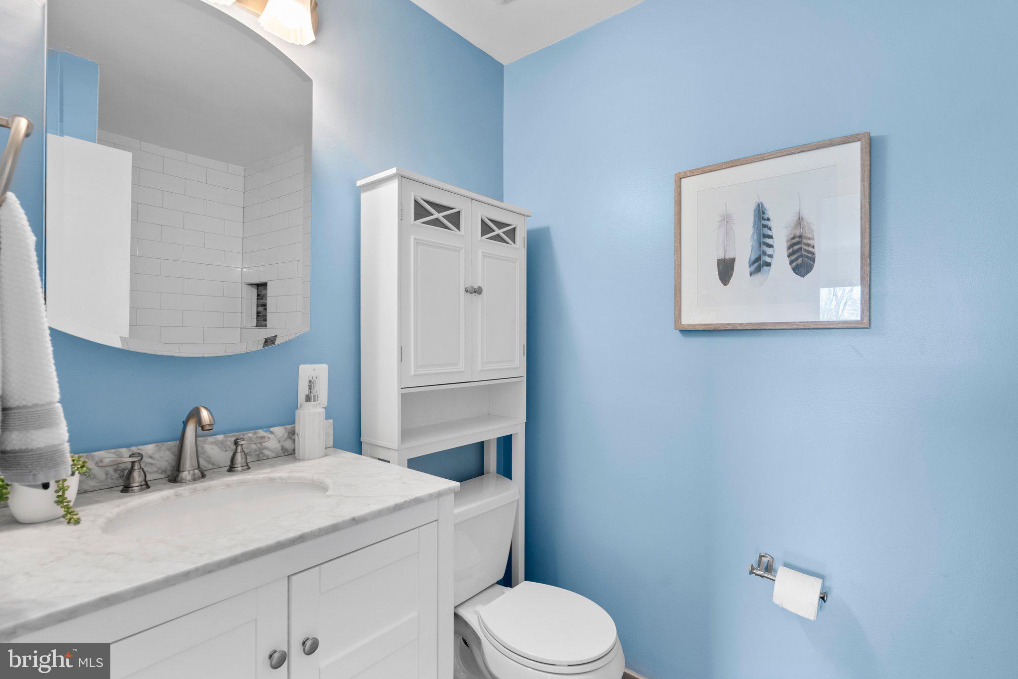 9828 Moyer Road Damascus, MD 20872 - Photo 24 of 46 a bathroom with a granite countertop toilet sink and mirror