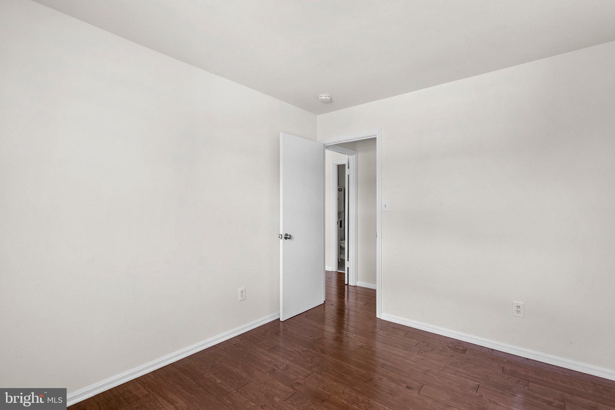 9828 Moyer Road Damascus, MD 20872 - Photo 27 of 46 a view of an empty room with wooden floor