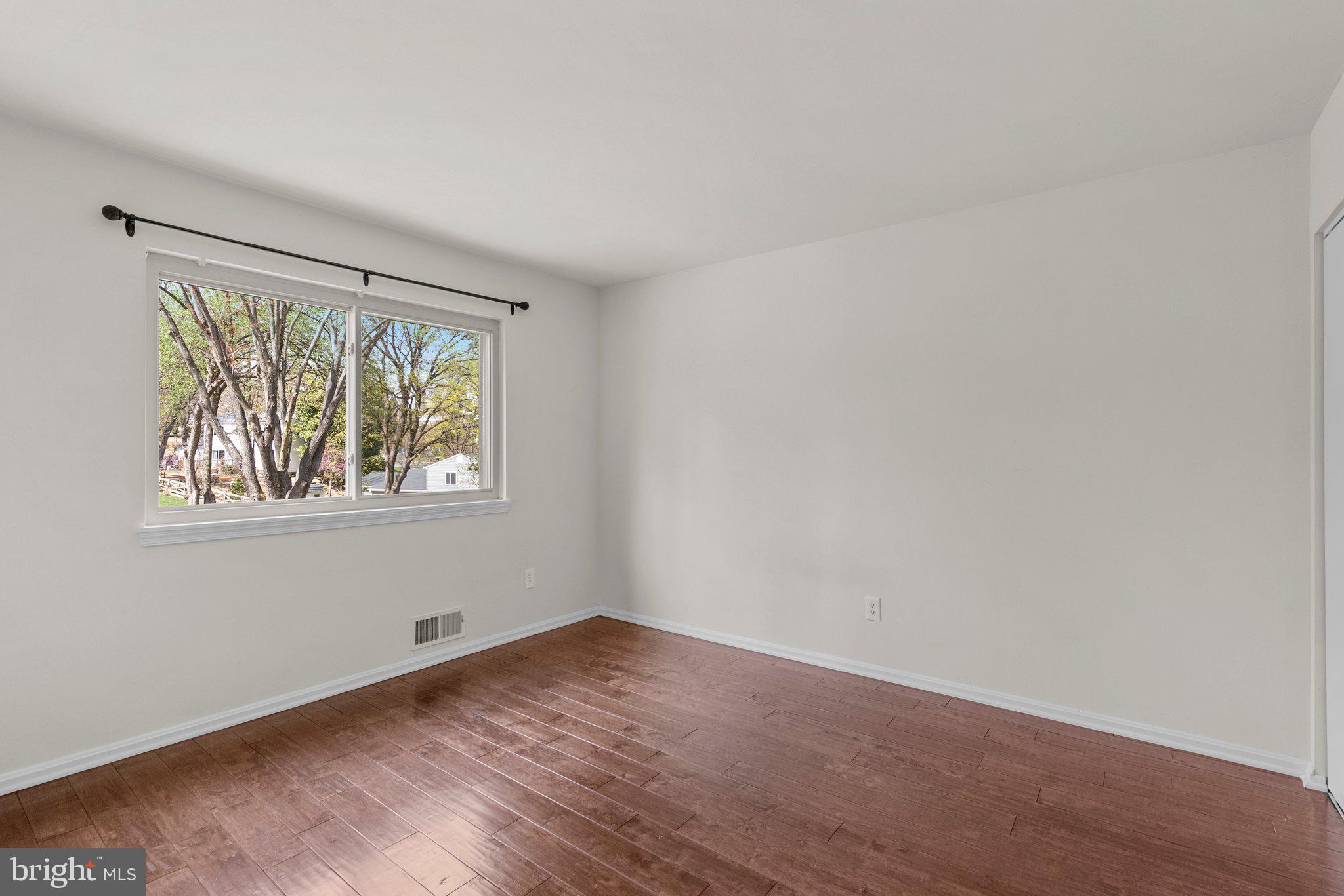 9828 Moyer Road Damascus, MD 20872 - Photo 28 of 46 an empty room with wooden floor and windows