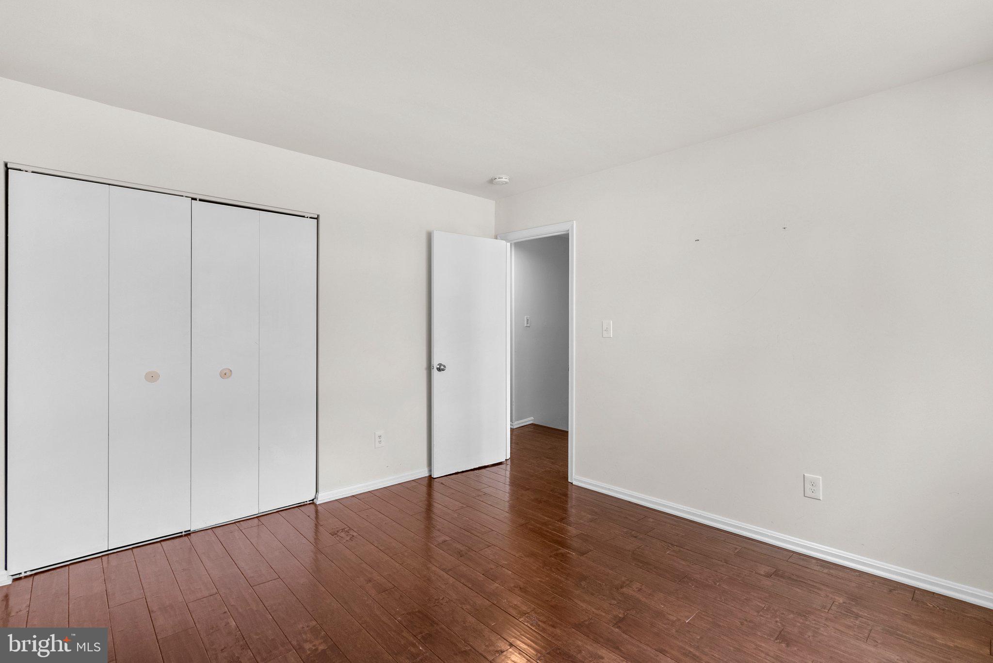 9828 Moyer Road Damascus, MD 20872 - Photo 29 of 46 a view of an empty room with wooden floor