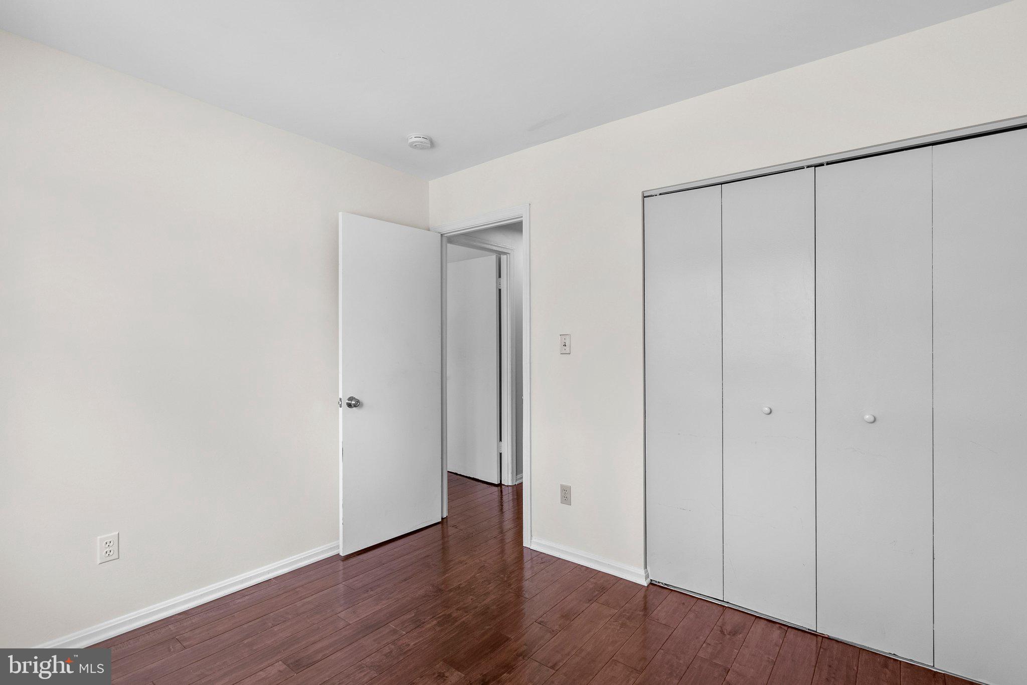 9828 Moyer Road Damascus, MD 20872 - Photo 31 of 46 a view of an empty room with wooden floor