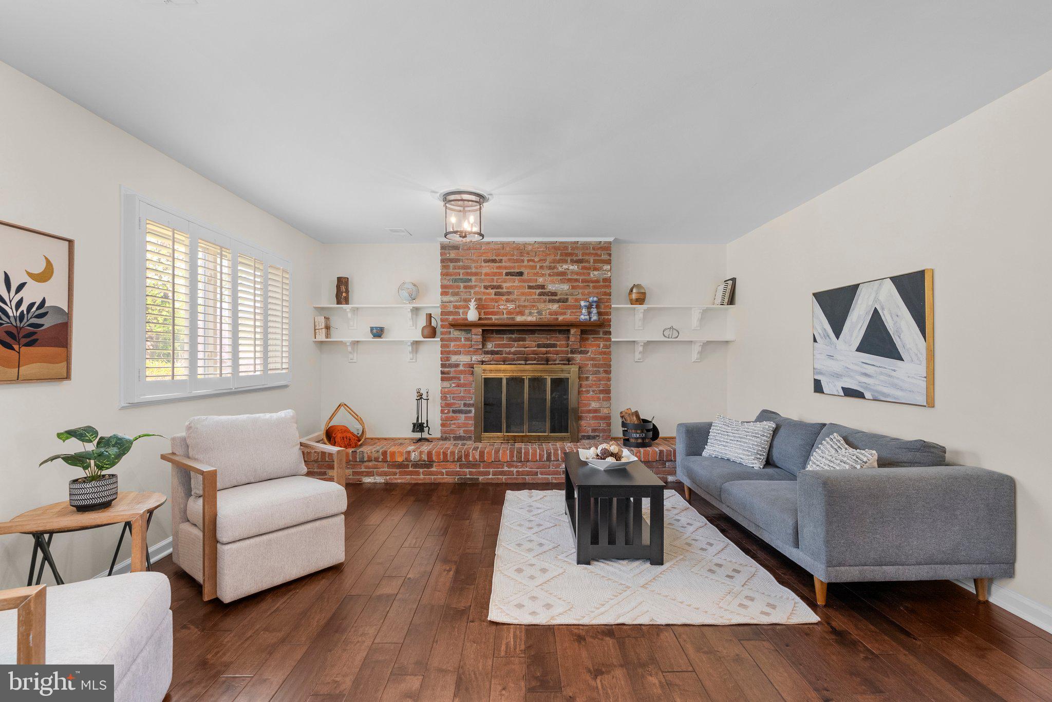 9828 Moyer Road Damascus, MD 20872 - Photo 33 of 46 a living room with furniture and a fireplace