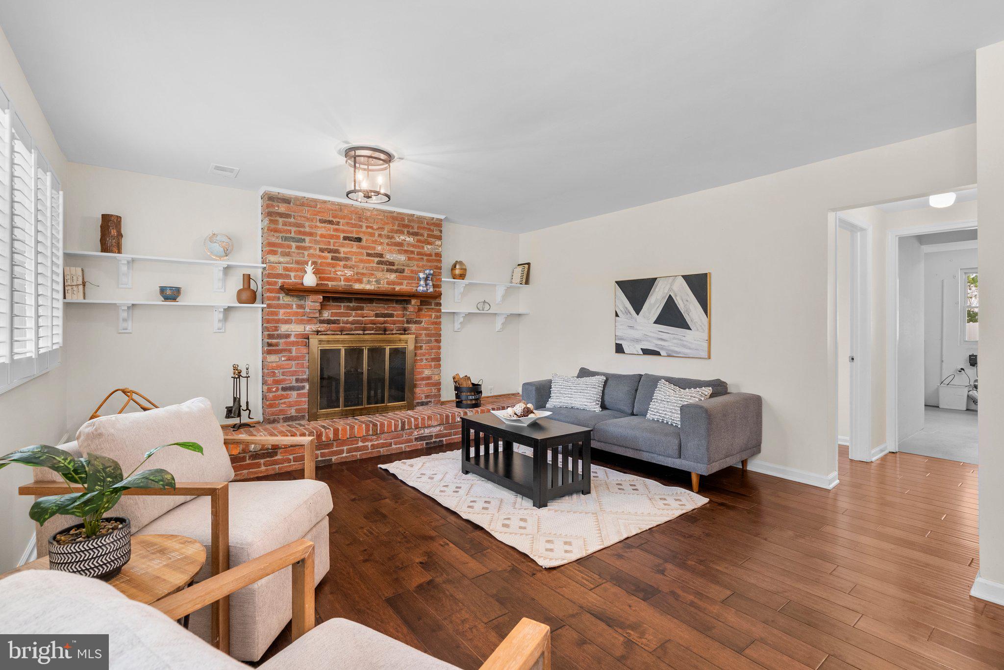 9828 Moyer Road Damascus, MD 20872 - Photo 34 of 46 a living room with furniture fireplace and wooden floor
