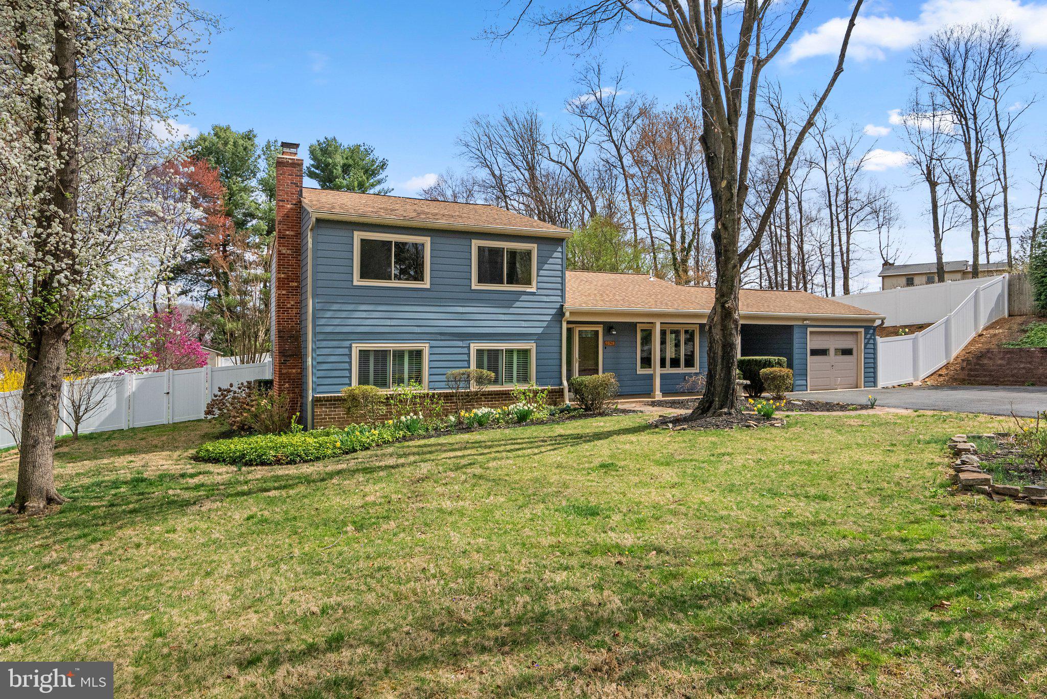 9828 Moyer Road Damascus, MD 20872 - Photo 45 of 46 a front view of a house with a garden