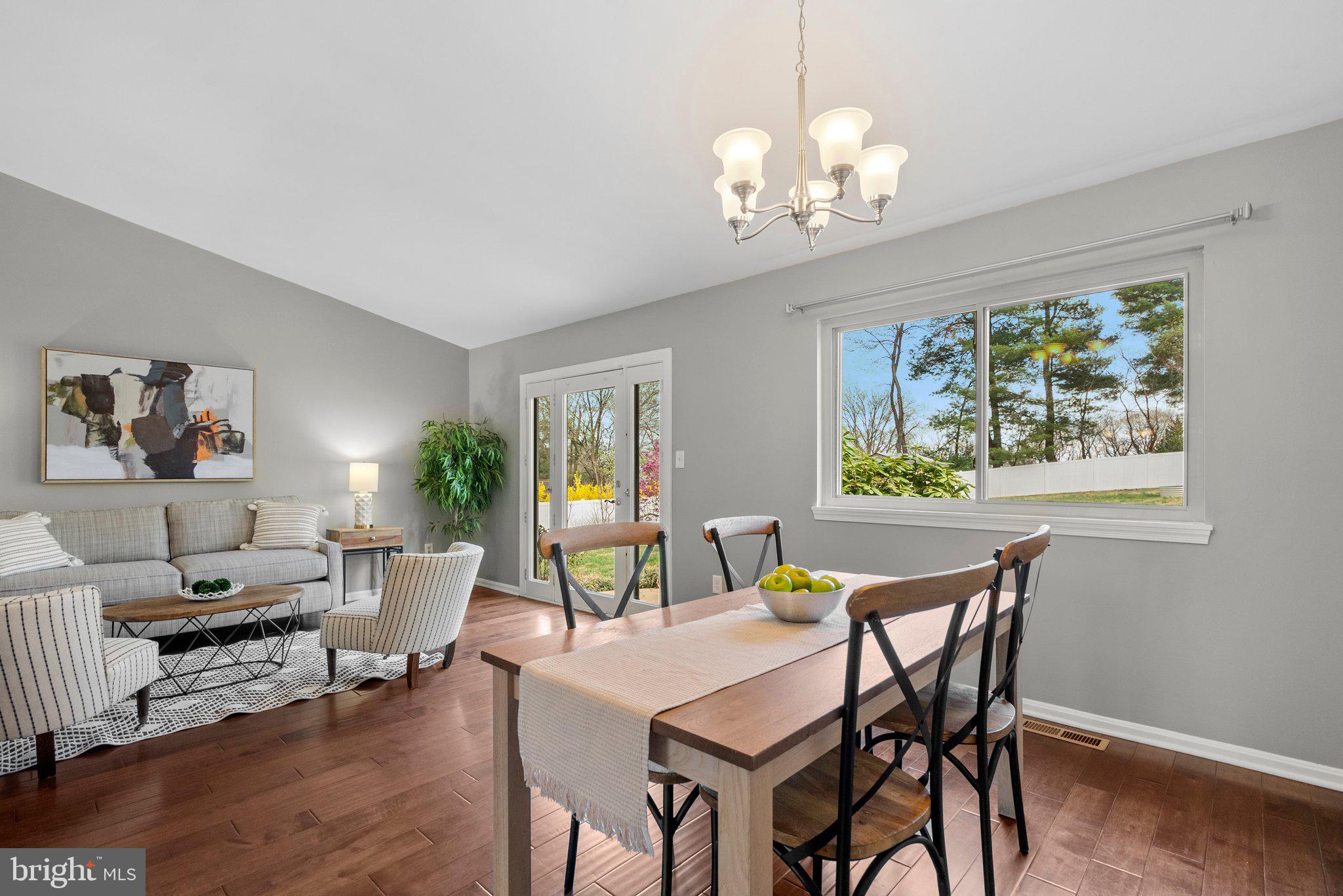 9828 Moyer Road Damascus, MD 20872 - Photo 7 of 46 a view of a dining room with furniture a chandelier and wooden floor