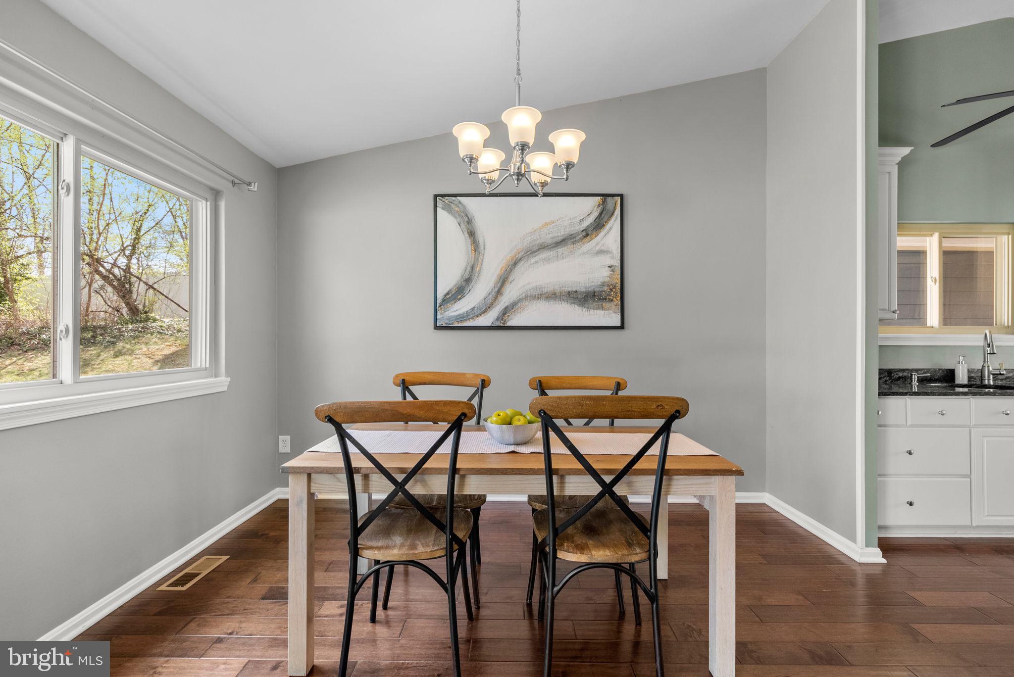 9828 Moyer Road Damascus, MD 20872 - Photo 9 of 46 a view of a dining room with furniture window and wooden floor