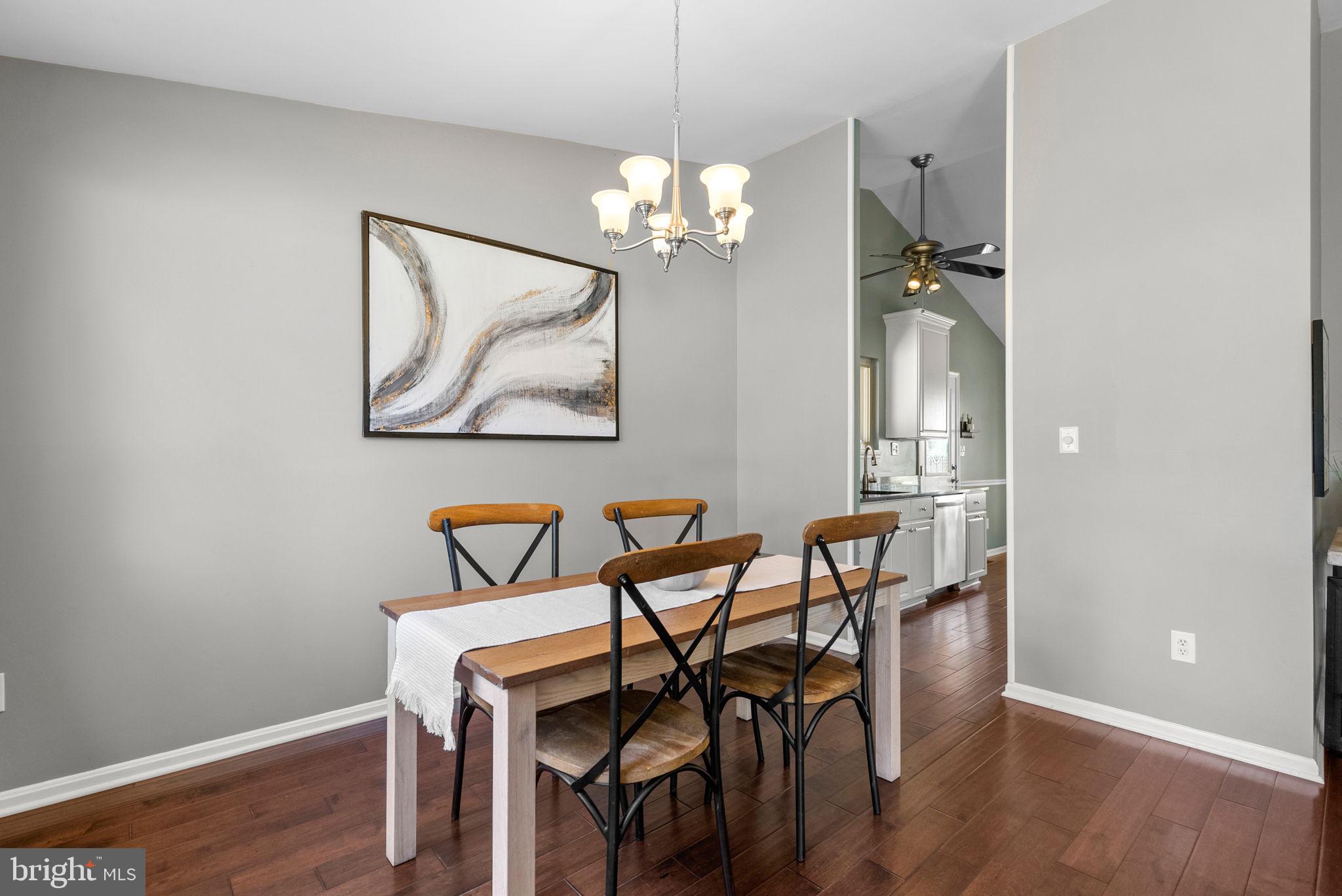 9828 Moyer Road Damascus, MD 20872 - Photo 10 of 46 a view of a dining room with furniture and wooden floor