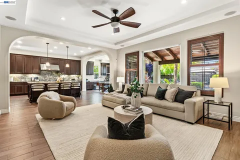 a large kitchen with stainless steel appliances a stove center island a wooden floor