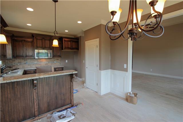 776 Academy Road, Unit 6C Lebanon, TN 37087 - Photo 7 of 16 a kitchen with kitchen island a counter space a sink and appliances