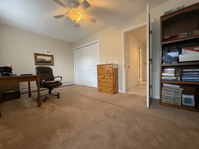 a view of a livingroom with furniture and a ceiling fan