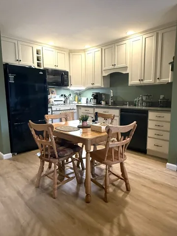 a kitchen with a table chairs a sink and cabinets