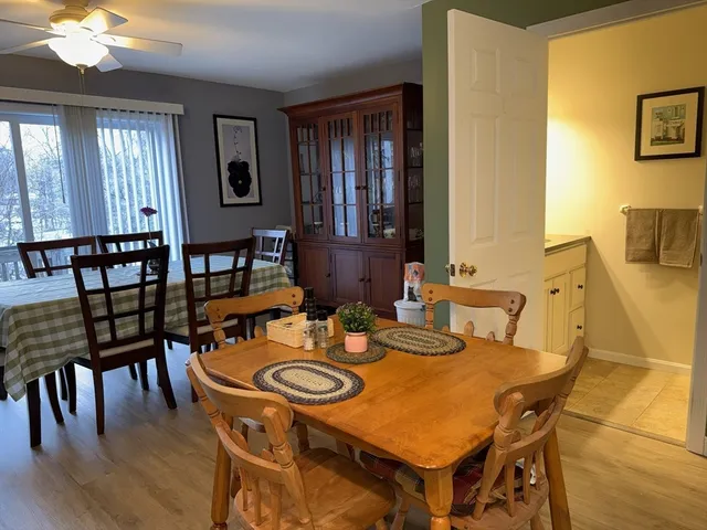 a view of a dining room with furniture and chandelier