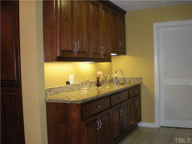 3417 Hackney Court Raleigh, NC 27613 - Photo 4 of 23 Wet bar is located just off of the kitchen for more entertaining space. More beautiful granite and cherry cabinets for extra storage. Door leads into large pantry/storage area. Kitchen