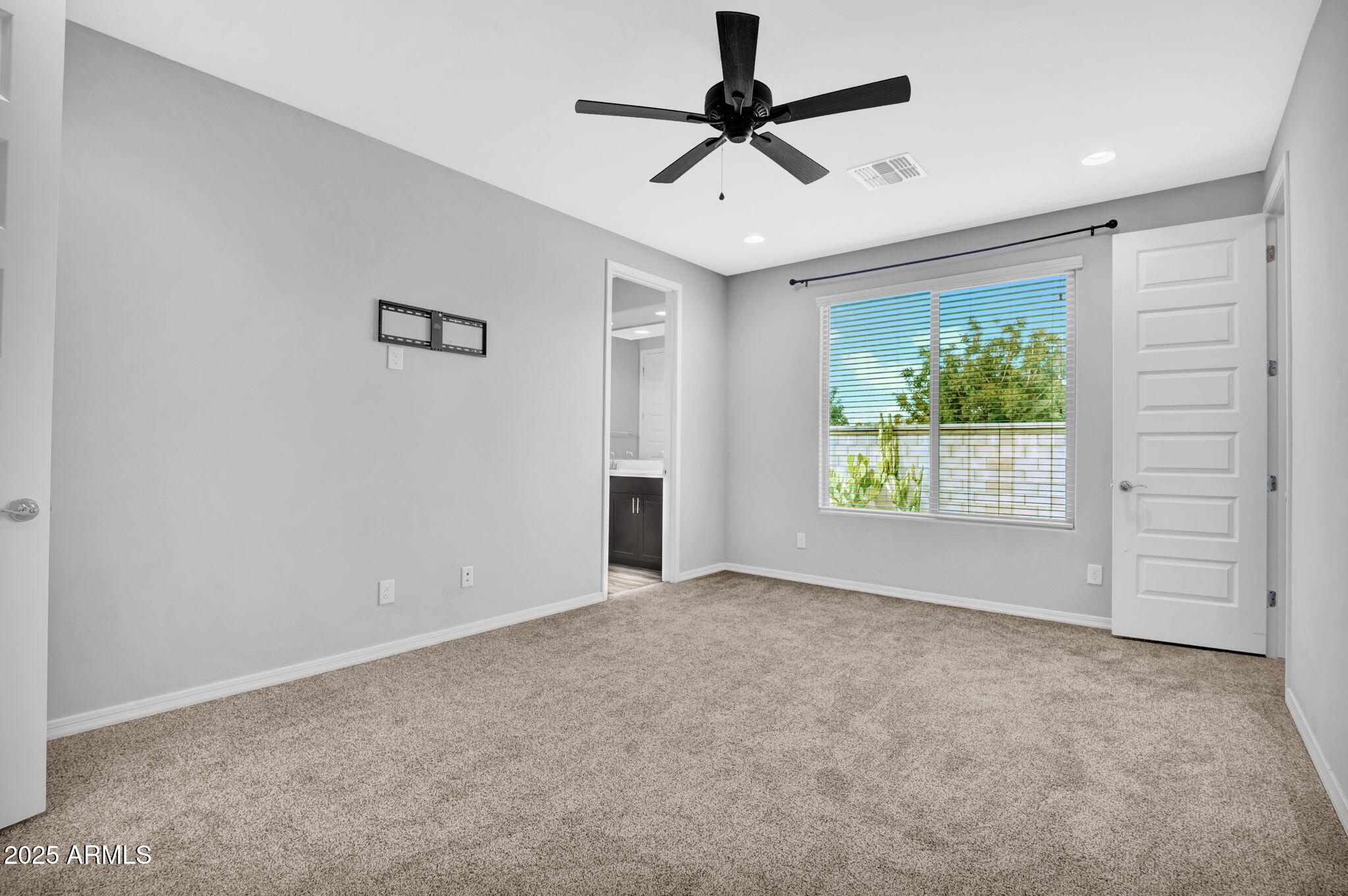 6562 South 24th Place Phoenix, AZ 85042 - Photo 11 of 22 an empty room with windows and ceiling fan