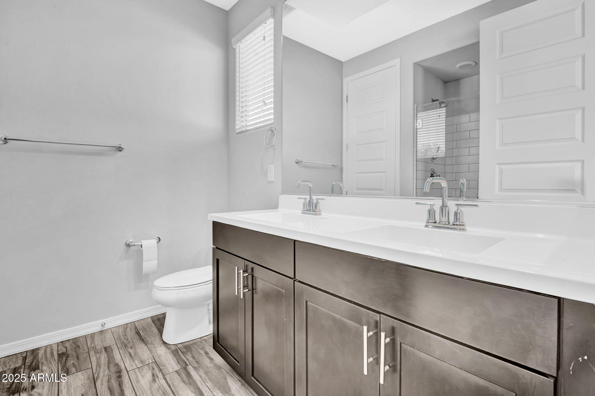 6562 South 24th Place Phoenix, AZ 85042 - Photo 12 of 22 a bathroom with a sink a toilet and a mirror
