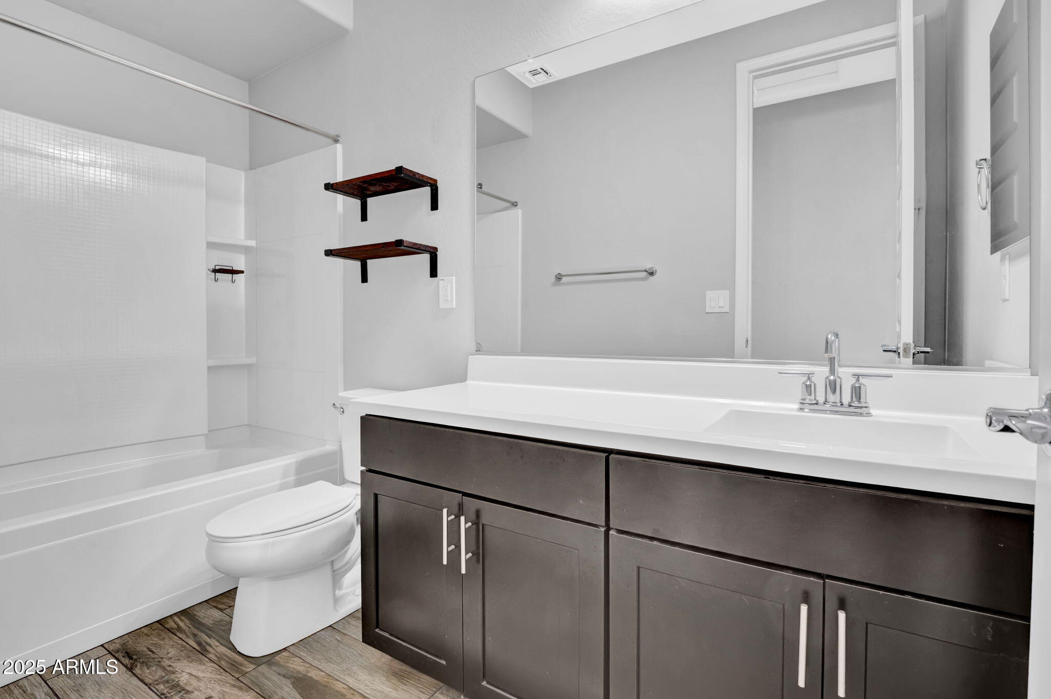 6562 South 24th Place Phoenix, AZ 85042 - Photo 17 of 22 a bathroom with a sink a toilet and shower