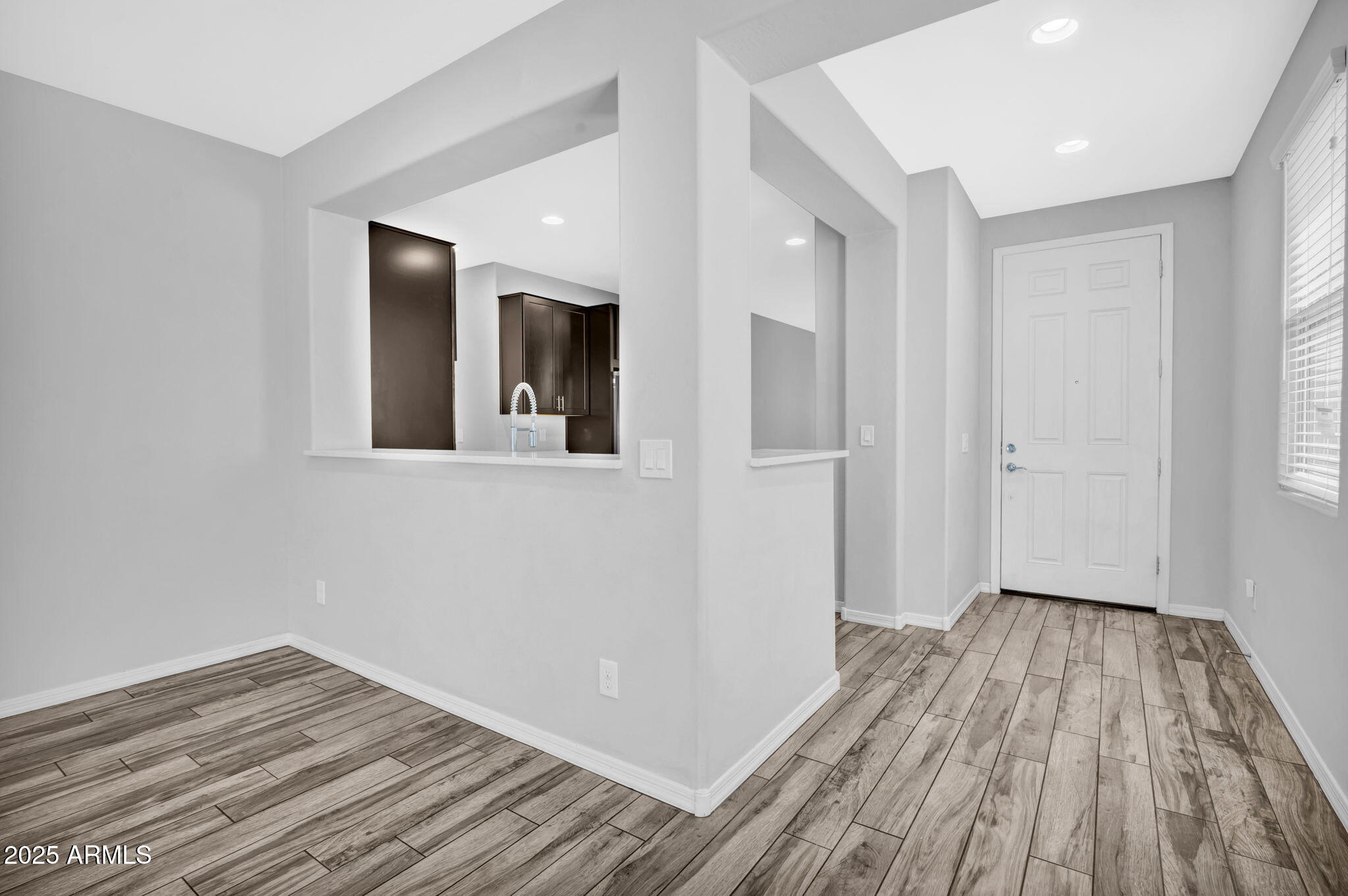 6562 South 24th Place Phoenix, AZ 85042 - Photo 3 of 22 wooden floor in an empty room with a window