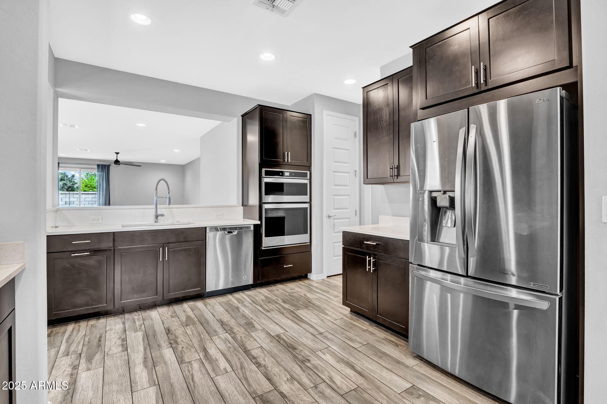 6562 South 24th Place Phoenix, AZ 85042 - Photo 4 of 22 a kitchen with stainless steel appliances a refrigerator sink and stove