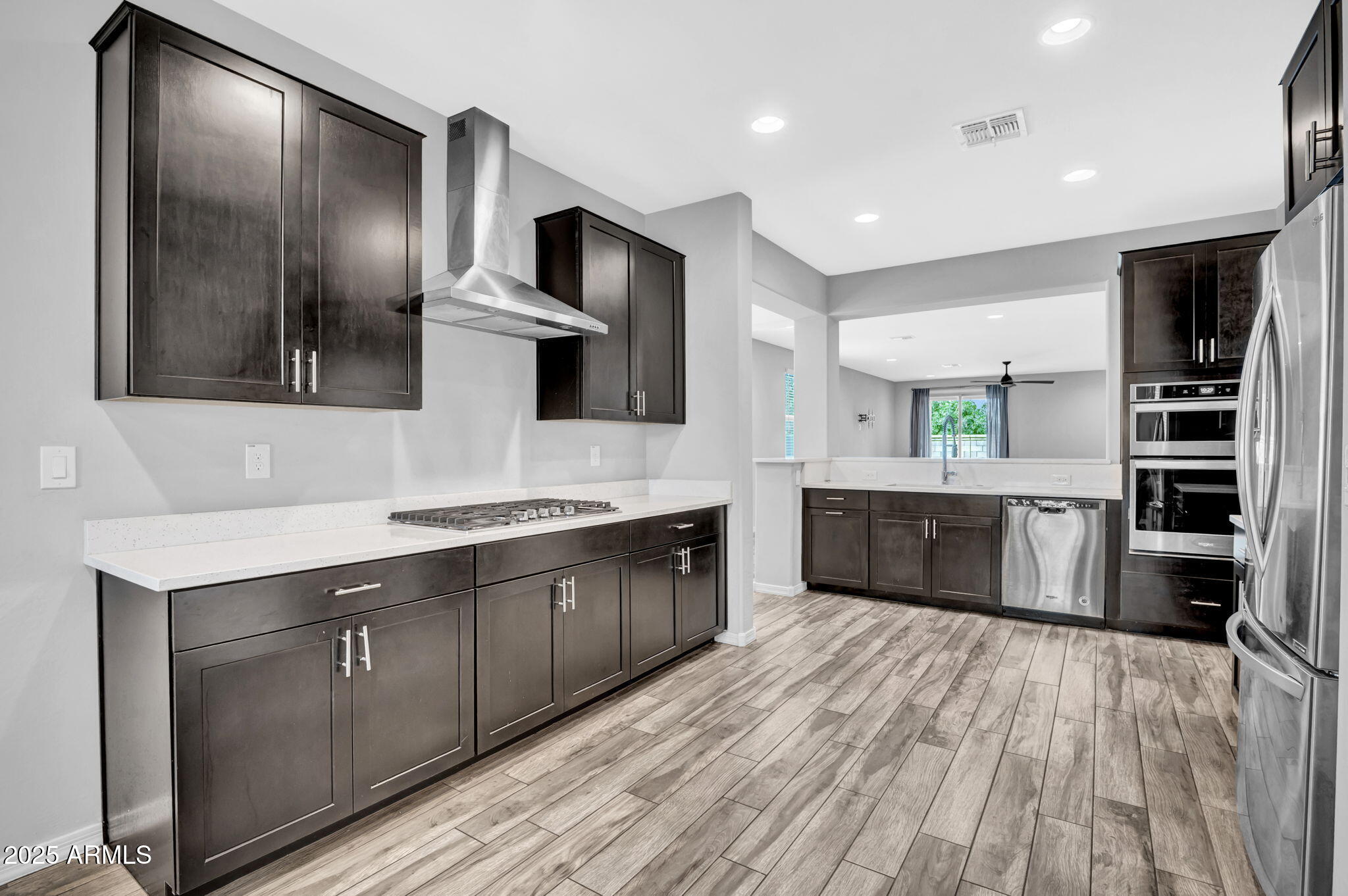 6562 South 24th Place Phoenix, AZ 85042 - Photo 5 of 22 a large kitchen with stainless steel appliances wooden cabinets a sink and a counter space