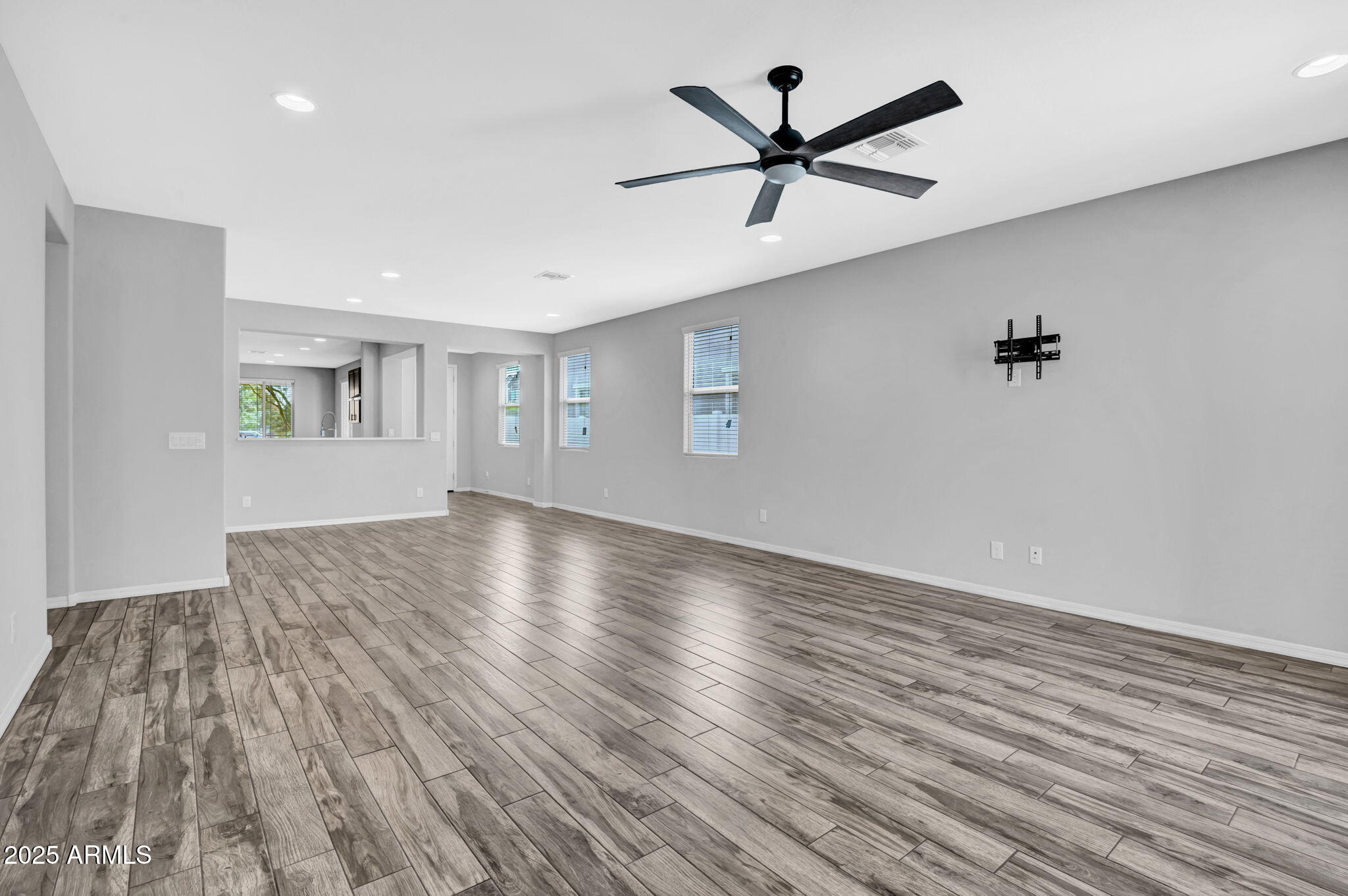 6562 South 24th Place Phoenix, AZ 85042 - Photo 9 of 22 a view of empty room with wooden floor and fan