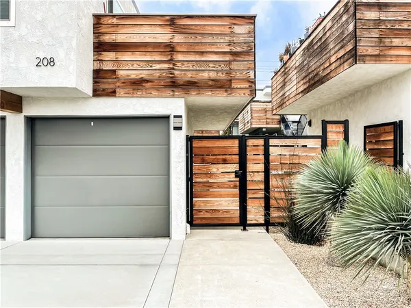 a view of a pathway of house with wooden fence